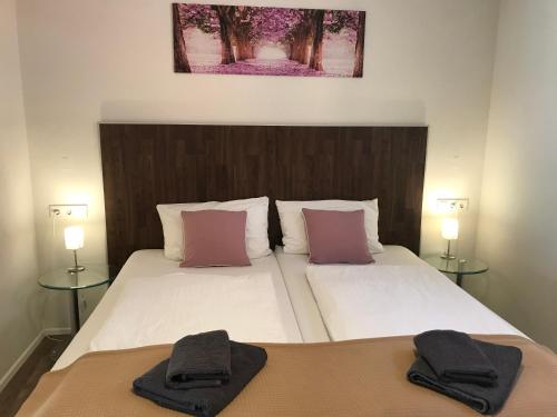 Dos camas en un dormitorio con dos toallas. en Königin Victoria - Appartement mit Saunanutzung, en Burgbernheim
