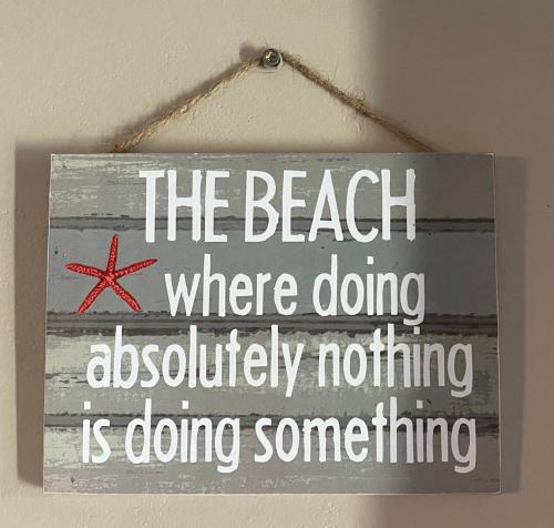 a sign that reads the beach where doing absolutely nothing is doing something at Kaiha (Witsand, Western Cape) in Witsand