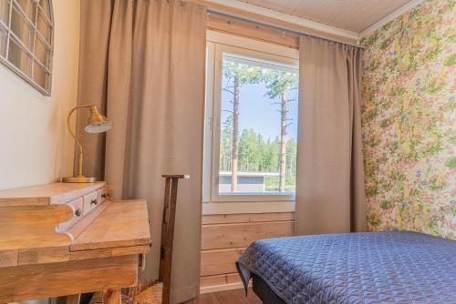 a bedroom with a bed and a window at Saimaa Life Apartments in Imatra
