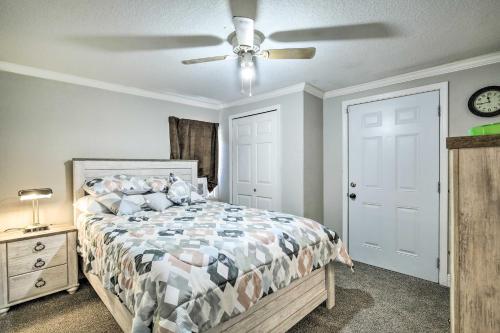 a bedroom with a bed and a ceiling fan at Updated Ybor City House with Fenced Yard in Tampa