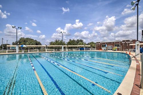 a large swimming pool with blue water at Updated Ybor City House with Fenced Yard in Tampa