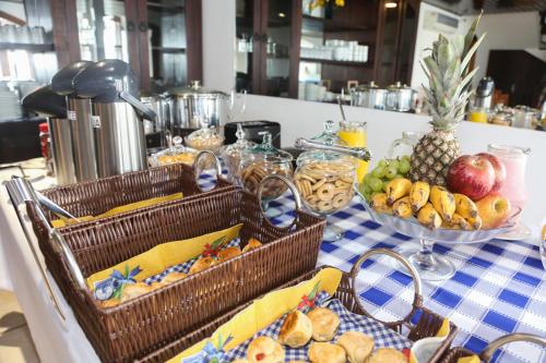 a table with baskets of fruit on a table at Pousada Praia Do Meio in Torres