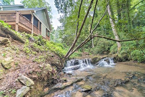 a waterfall next to a house next to a creek at Hootenanny at Horton Creek Creekside Escape! in Helen