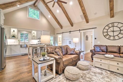 a living room with leather furniture and a kitchen at Hootenanny at Horton Creek Creekside Escape! in Helen