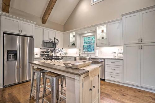 a kitchen with white cabinets and stainless steel appliances at Hootenanny at Horton Creek Creekside Escape! in Helen