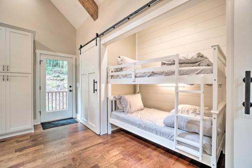 a bedroom with bunk beds in a room with wooden floors at Hootenanny at Horton Creek Creekside Escape! in Helen