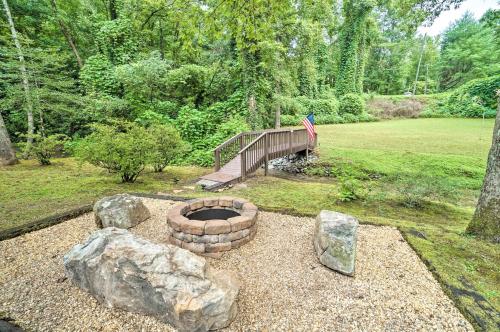 a fire pit in a yard next to a bridge at Hootenanny at Horton Creek Creekside Escape! in Helen