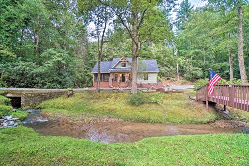 a house on a hill with a bridge and an american flag at Hootenanny at Horton Creek Creekside Escape! in Helen