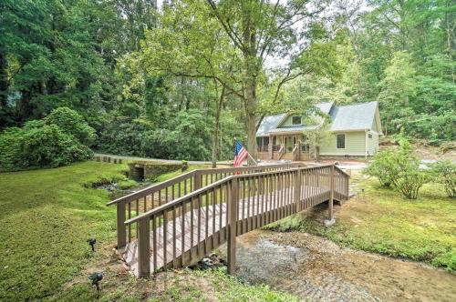 a house with a wooden bridge with an american flag on it at Hootenanny at Horton Creek Creekside Escape! in Helen