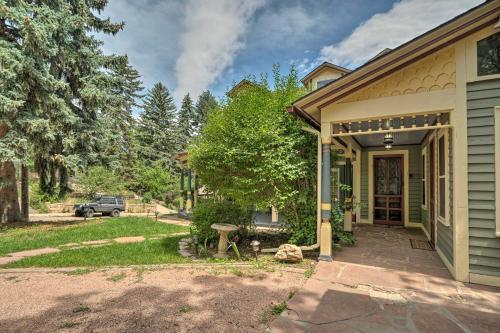 a house with a front porch and a driveway at Historic Manitou Springs Victorian Walk Downtown! in Manitou Springs