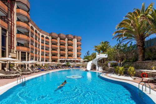 a person swimming in a pool at a resort at MUR Neptuno Gran Canaria - Adults Only in Playa del Ingles