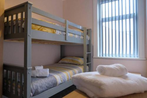 a bedroom with two bunk beds and a window at Westcliffe House in Blackpool