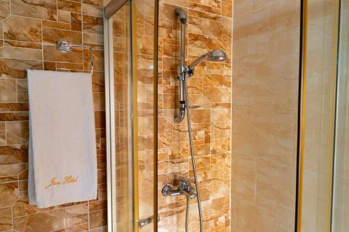 a bathroom with a shower with a towel on it at Java Hotel in Toamasina
