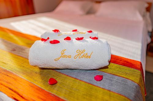 a towel on a bed with hearts on it at Java Hotel in Toamasina