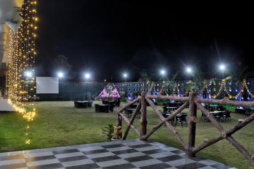 a christmas party in a park at night with lights at HOTEL HILL VIEW in Dehradun