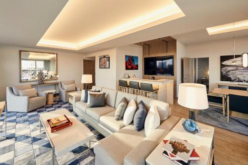 a living room with a couch and a tv at Live! by Loews - St. Louis in Saint Louis