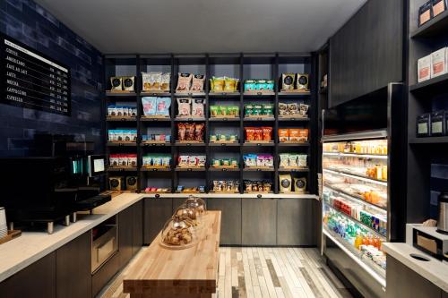 a grocery store with a counter and a refrigerator at Live! by Loews - St. Louis in Saint Louis
