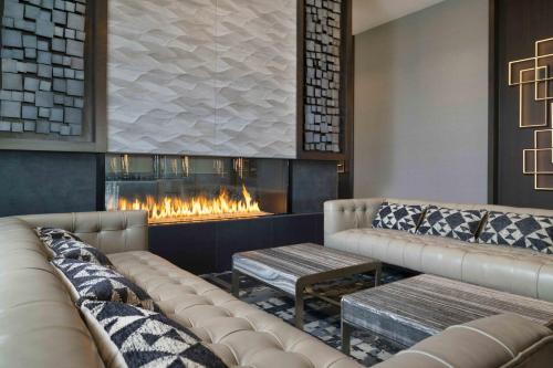 a lobby with two couches and a fireplace at Holiday Inn Express - Boston Logan Airport - Revere by IHG in Revere