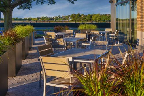 a row of tables and chairs on a patio at Holiday Inn Express - Boston Logan Airport - Revere by IHG in Revere