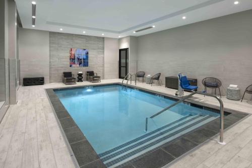 a large swimming pool in a hotel room at Holiday Inn Express - Boston Logan Airport - Revere by IHG in Revere