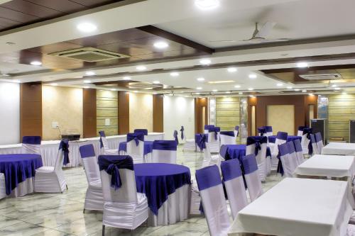 a banquet hall with blue and white tables and chairs at HOTEL HILL VIEW in Dehradun