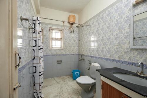 a bathroom with a toilet and a sink at Sweet Memories- Perfect home stay in Chennai