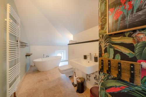 a bathroom with a white tub and a sink at Design Apartments - "Villa Arnim" in Potsdam