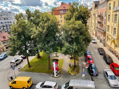 a city street with cars parked in a parking lot at Das Nikolai Hotel in Munich