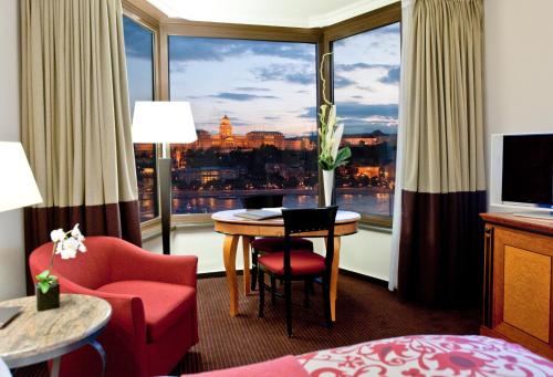 a hotel room with a table and a large window at Sofitel Budapest Chain Bridge in Budapest