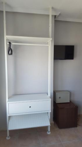a white cabinet with a tv in a room at Hotel Central Torrevieja in Torrevieja