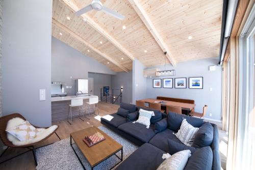 a living room with a blue couch and a table at Cherrywoods Place by Hakuba White Fox Company in Hakuba
