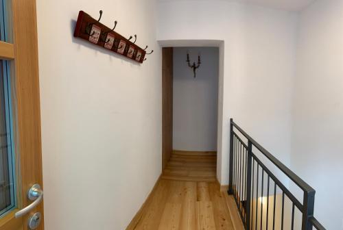 einen Flur mit weißen Wänden und einer Treppe in der Unterkunft Casa al Sole Apt 1 in Pinzolo