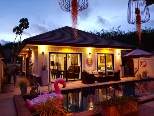 a house with a swimming pool in front of a house at Sila Thai Pool Villa1 in Ao Nang Beach