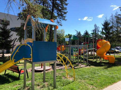 a park with a playground with slides and play equipment at Ośrodek Promenada- Horyzont in Jastrzębia Góra