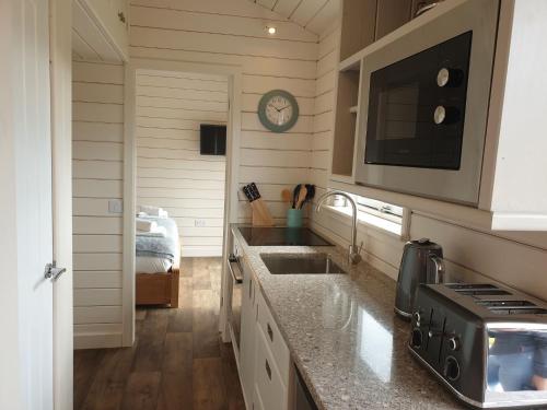 a kitchen with a sink and a microwave at Toradh Cabin in Spean Bridge