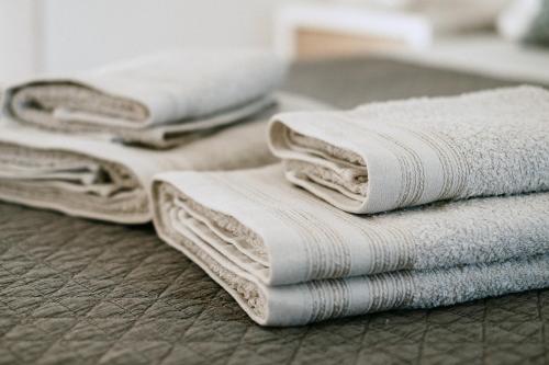 a pile of white towels sitting on the floor at The Douro Nest in Valença do Douro
