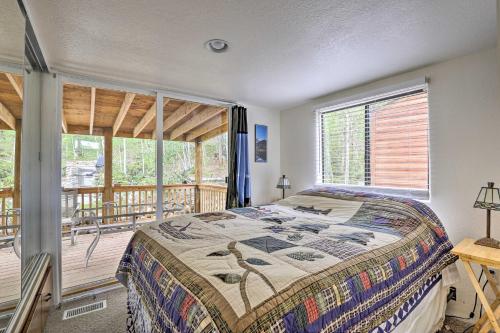 a bedroom with a bed and a balcony at Bright Fairplay Cabin with Deck and All-Seasons Fun! in Fairplay