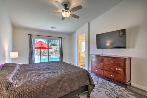 a bedroom with a bed and a flat screen tv at Coachella Retreat Pool, Near Music Festivals in Coachella