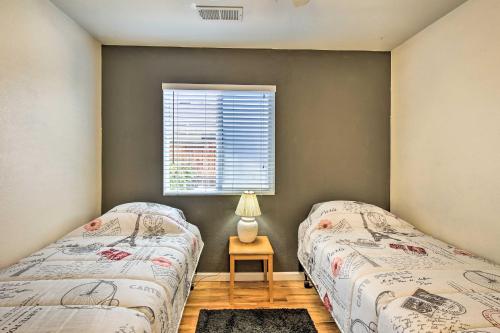 two beds in a room with a window at Coachella Retreat Pool, Near Music Festivals in Coachella