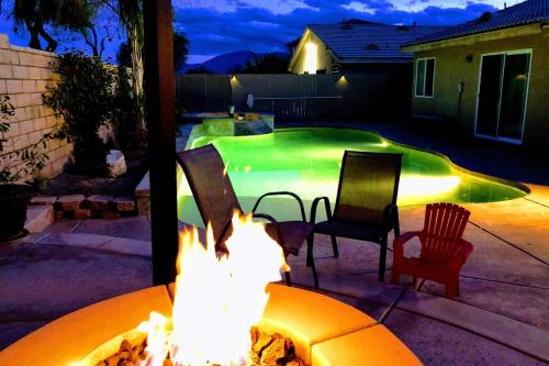 a backyard with a fire pit and a swimming pool at Coachella Retreat Pool, Near Music Festivals in Coachella
