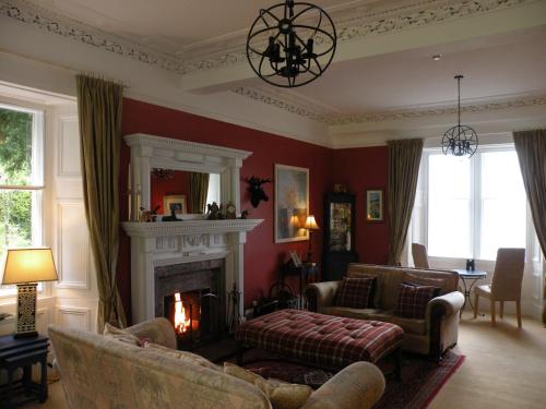 
a living room filled with furniture and a fire place at Thistle House Guest House in Saint Catherines
