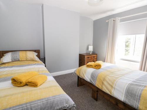 a bedroom with two beds and a window at Ryeby Garth in Hull