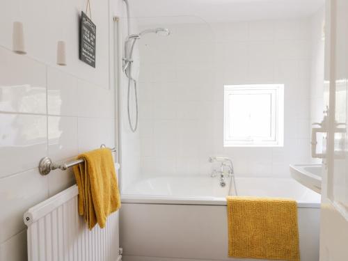 a white bathroom with a tub and a sink at Ryeby Garth in Hull