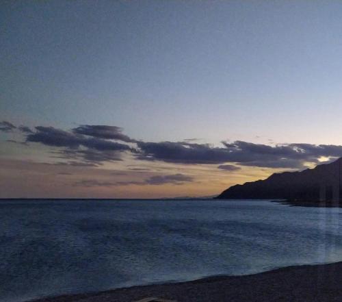 a view of the ocean at sunset at COSMOS nature Lodge and Spiritual community in Dahab