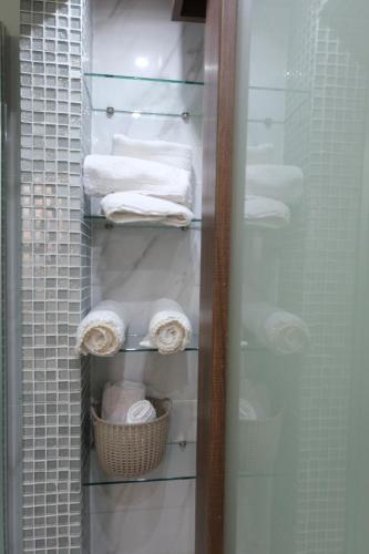 a closet with towels and a basket of towels at Luxury Fani House Next to Harbor area with Jacuzzi in Paphos