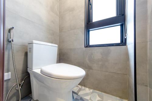 a bathroom with a toilet and a window at The Lin Inn in Kenting