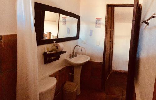 a bathroom with a sink and a mirror at La Serrana Hostal Spa in Socorro