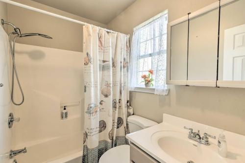 a bathroom with a sink and a shower curtain at half Mi to Sand Surfside Beach Retreat! in Surfside Beach