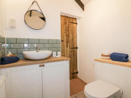 a bathroom with a sink and a toilet at Trenant Cottage in Fowey