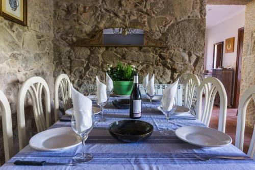 a table with a blue table cloth and a bottle of wine at Chalet en Canido in Vigo